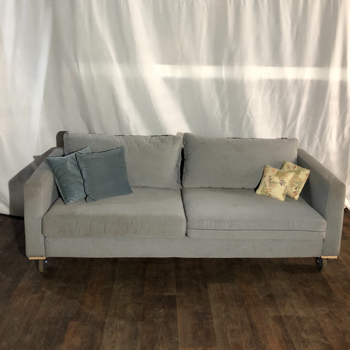 grey couch on castors 