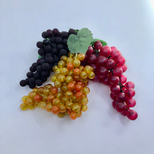 Three different bunches of plastic grapes