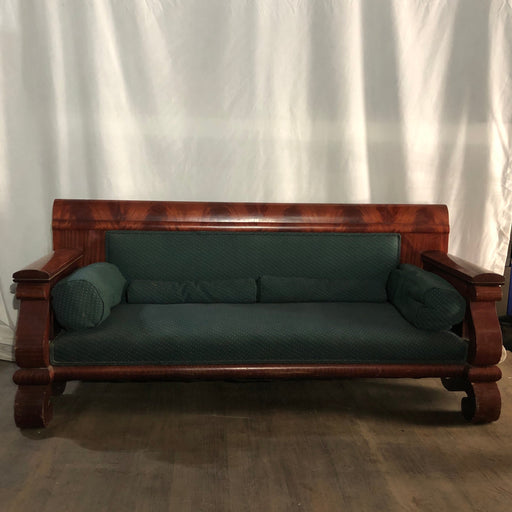 Large wooden couch with green cushions