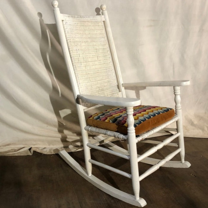  White Rocking Chair with Rainbow Cushion.