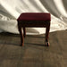 padded red stool with grommet accents