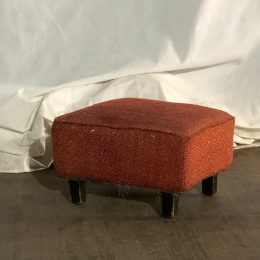 red padded footstool
