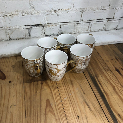 white and gold mugs